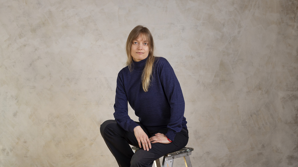 Terhi Nieminen sits on a stool.